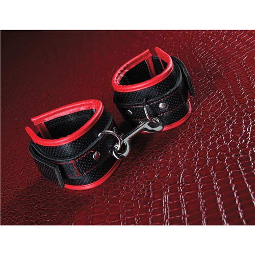 A&E's Scarlet Bound To Surrender Cuffs with cuffs on red background