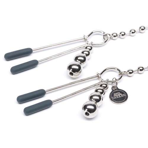 Fifty Shades Darker Beaded Chain Nipple Clamps laying on table