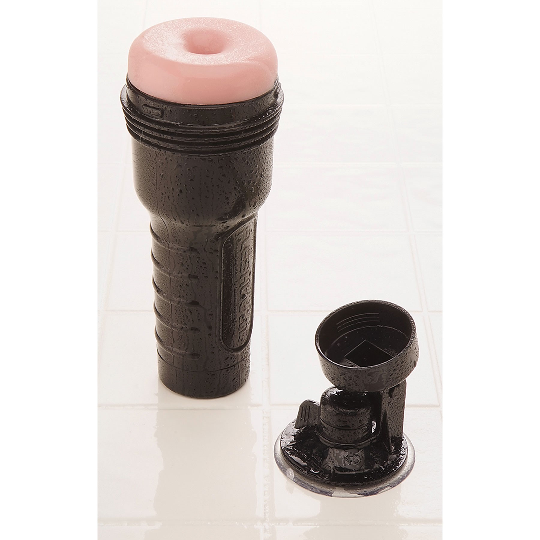 Fleshlight Shower Mount on table next to a fleshlight