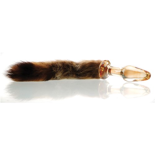 Foxxxy Fox Tail Glass Anal Plug laying on table