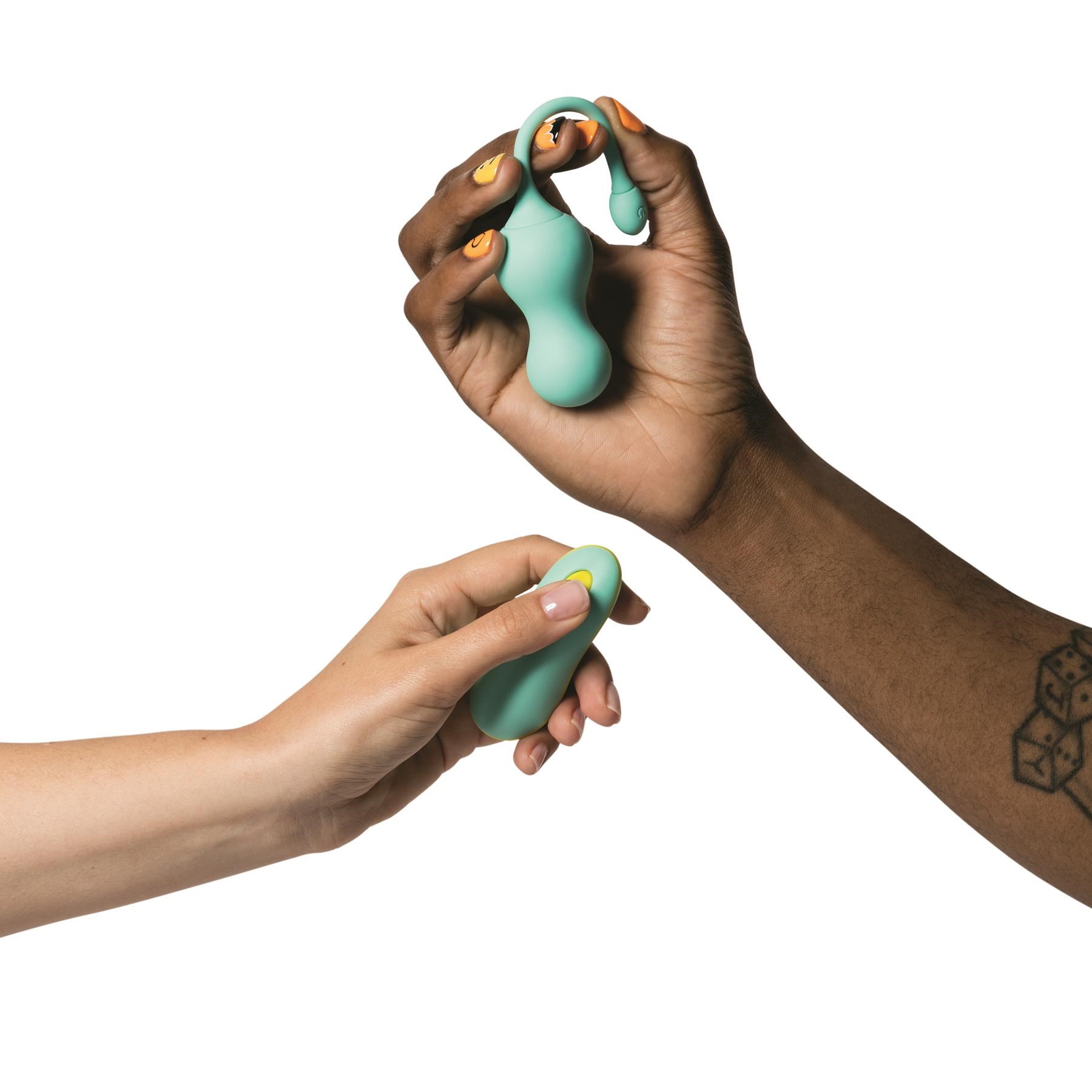 Romp Cello Vibrating Egg - Hand Shot with Vibrator and Remote