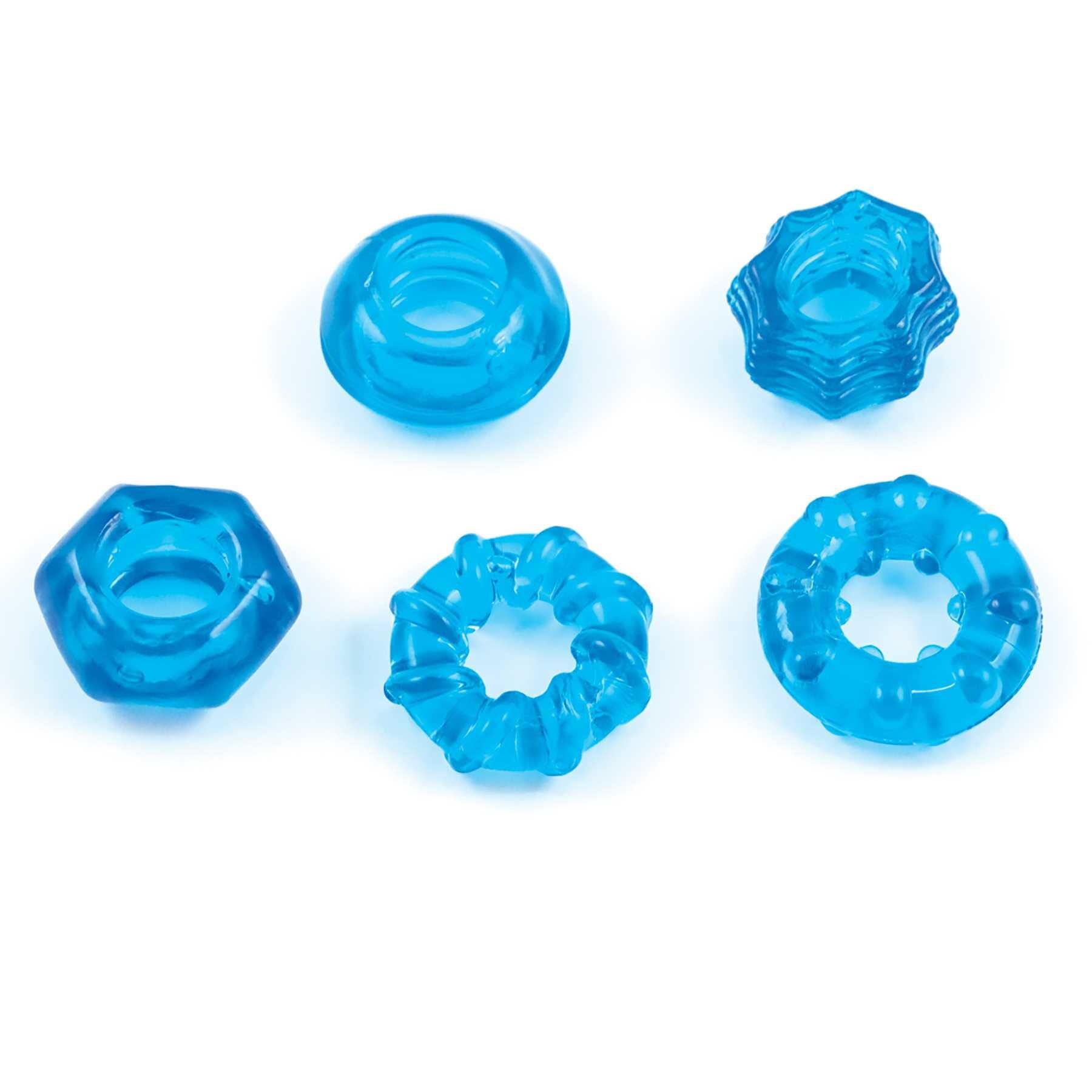 ENHANCER FIVE PIECE COCK RING SET-BLUE laying on table