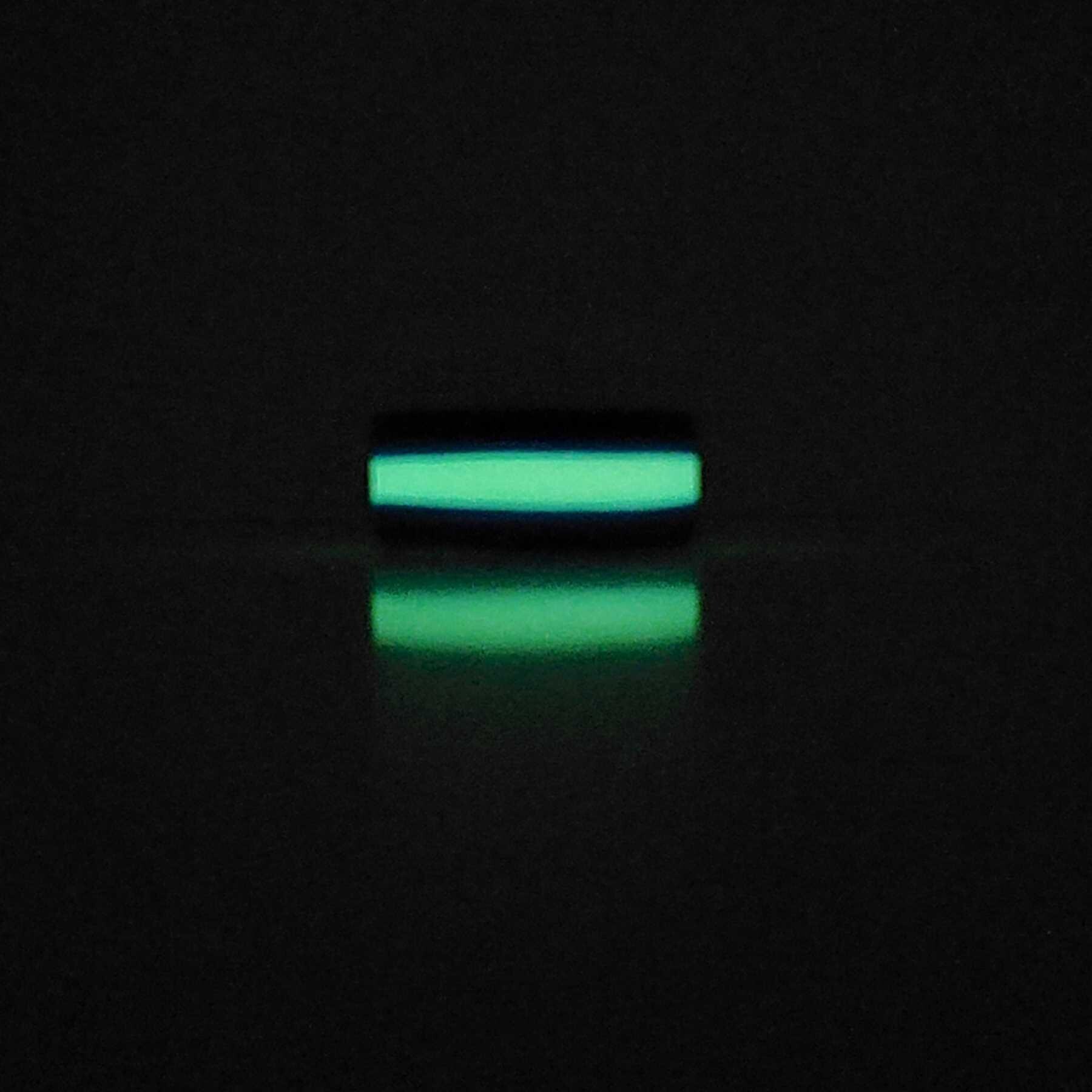 Stripes Glow In the Dark Cock Ring glowing in the dark laying on table