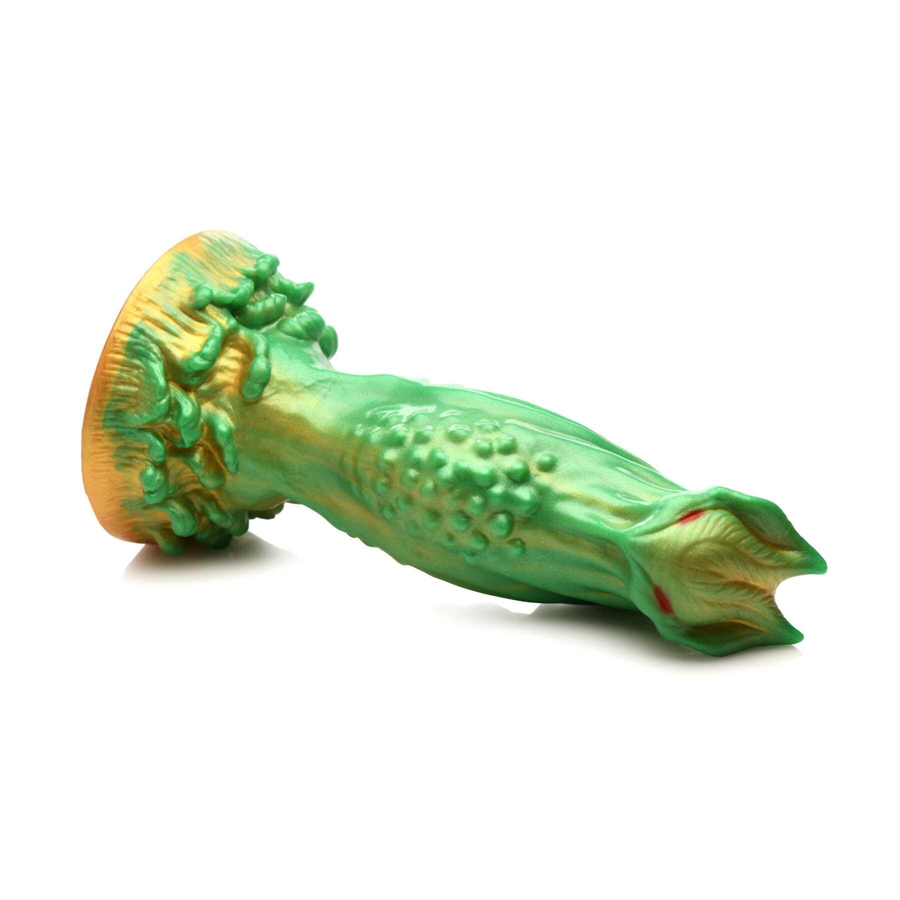 CREATURE COCKS NEBULA ALIEN DILDO laying on table