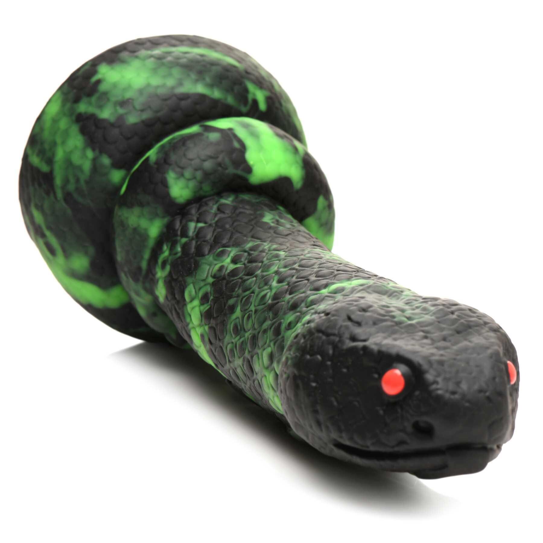 CREATURE COCKS PYTHON SILICONE DILDO laying on table