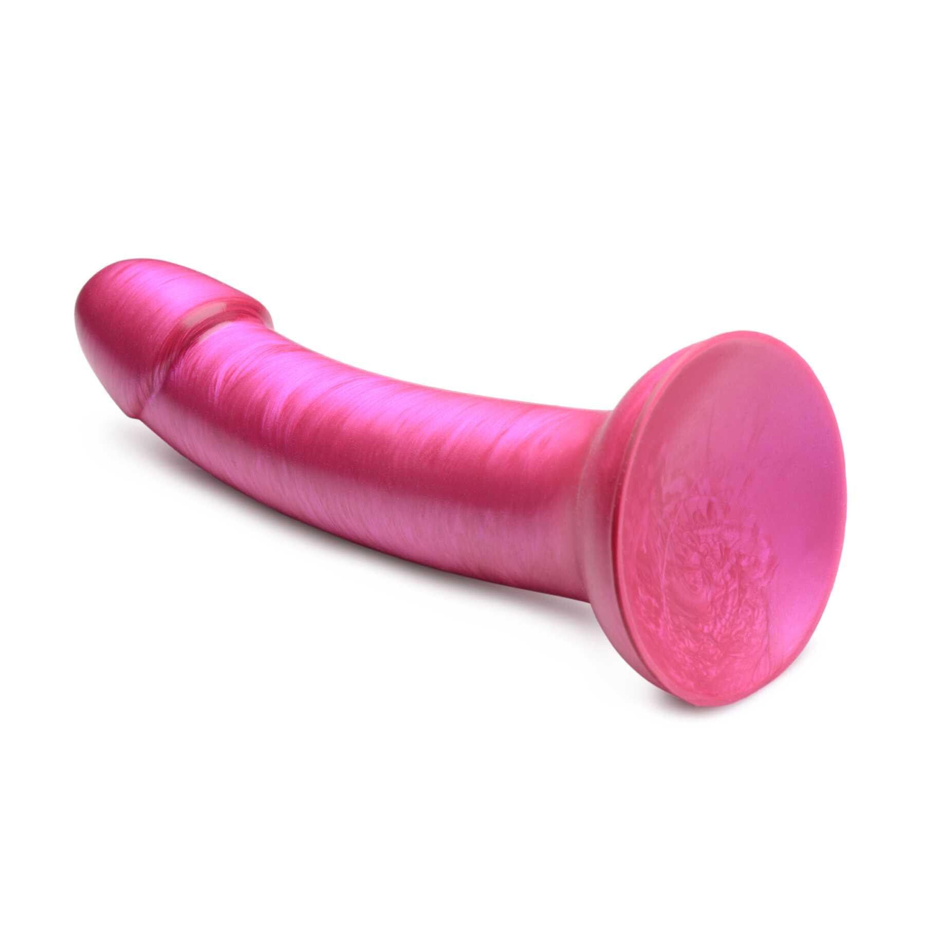 7 Inch Metallic Silicone Dildo pink laying on table