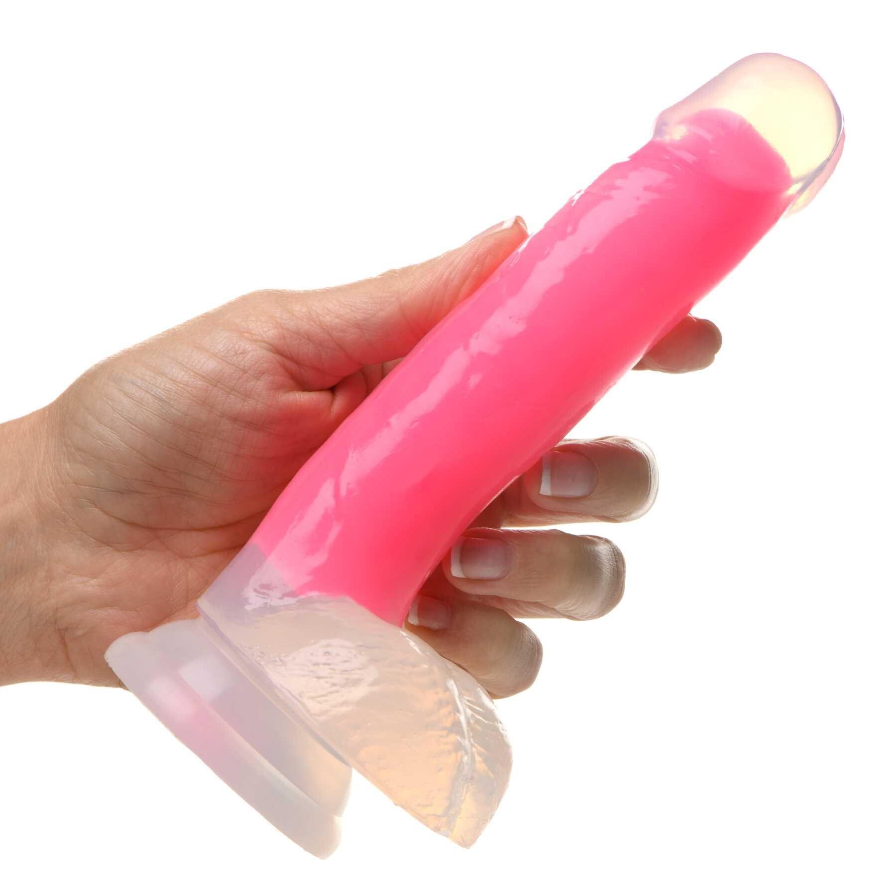 7 Glow-in-the-Dark Silicone Dildo w Balls pink hand holding for scale