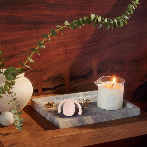 Dame Massage Candle on table burning